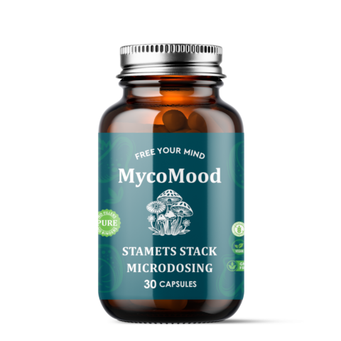 Amber supplement bottle with teal label reading “MycoMood” and “Stamets Stack Microdosing,” 30 capsules, with mushroom illustration and vegan/GMO-free style icons.